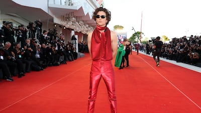 Timothee Chalamet wears metallic red Haider Ackermann for the 'Bones and All' premiere at the Venice International Film Festival on September 2. Getty
