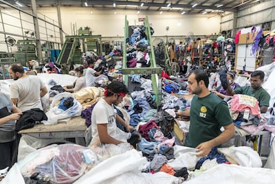 Every day, the 100,000 square foot facility in Sharjah handles 60 tonnes of used clothing for export to Africa. Antonie Robertson / The National