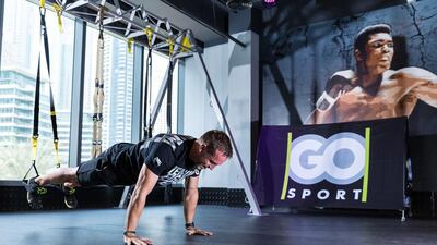 Trainer Danny Bartlett demonstrates how to use the TRX suspension training equipment at the Go Sport Product launch. Courtesy Go Sport