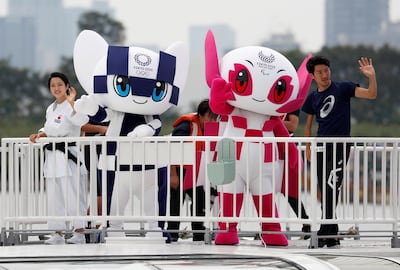 Tokyo 2020 mascots Miraitowa and mascot Someity wave with Japan's Paralympic long-jumper Hajimu Ashida and karateka Kiyo Shimkizu. Reuters
