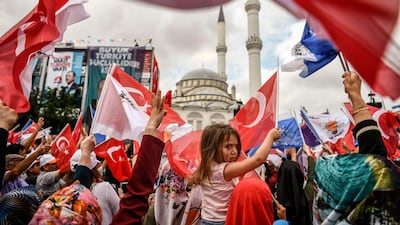People attend a speech of Turkish President Recep Tayyip Erdogan one day before the elections in Istanbul, Turkey, on June 23, 2018. Aris Messinis / AFP