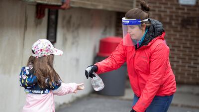 A pupil has her hands sanitised in the schoolyard, as schools outside the greater Montreal region begin to reopen their doors, Saint-Jean-sur-Richelieu, Quebec, Canada, May 11. Christinne Muschi / Reuters