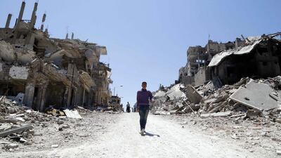 Residents arrive on foot to inspect their homes in the Wadi Al Sayeh district. Omar Sanadiki/Reuters