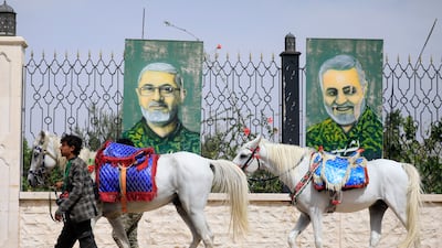Horsemen pass murals commemorating Iranian commanders in Sanaa. Yemen's government has accused Iran and its regional allies of supporting and managing the Houthis' recent offensive,EPA