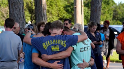 People comfort each other at a vigil set up close to Santa Fe High School where a gunman shot numerous people in Santa Fe, Texas. Matt Patterson / EPA