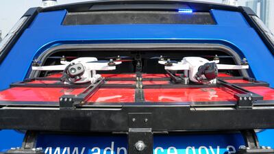 Two surveillance drones are stored at the back of the vehicle