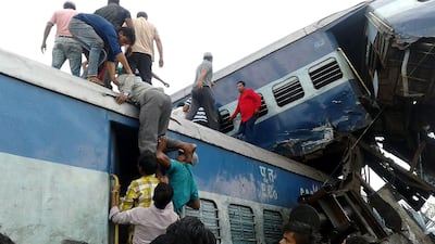 Local residents look for survivors on the wreckage of train carriages after an express train derailed near the town of Khatauli in the Indian state of Uttar Pradesh on August 19, 2017. Agence France-Presse