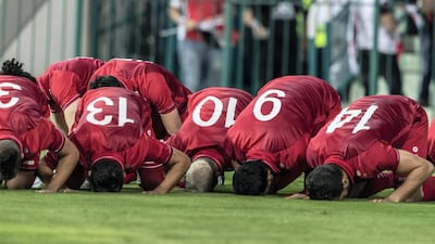 Syria players praying at Al Maktoum bin Rashid Stadium. Antonie Robertson/The National