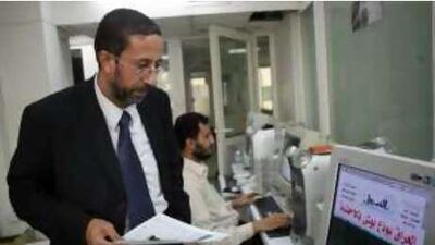 Atef Joulani, the editor in chief of Assabeel, checks on work at the newspaper's office in Amman.