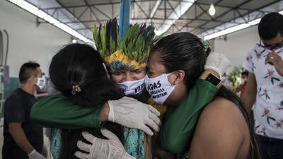 Indigenous people attend the funeral of the cacique Messias Kokama, 53, a victim of COVID-19, at the Parque de las Tribos in the city of Manaos, Amazonas state, Brazil, 14 May 2020. The cacique Messias Kokama, considered the main indigenous leader of the city of Manaos, capital of the Brazilian state of Amazonas, died a victim of the SARS-CoV-2 coronavirus and his community said goodbye to him this Thursday without being able to pay him all the tributes with their traditional rituals. EPA