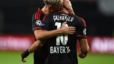 Bayer Leverkusen's Hakan Calhanoglu celebrates with teammate Kevin Kampl after a goal in their 4-1 Champions League win over Bate Borisov on Wednesday in the Champions League. Patrik Stollarz / AFP