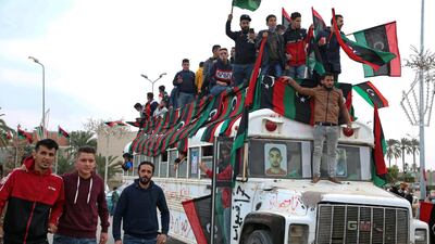 A bus is decorated with flags to celebrate the 2011 uprising in Libya. AFP