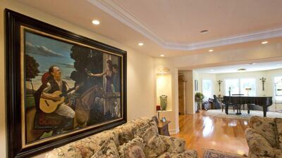 A painting depicting 1970’s heartthrob David Cassidy, left, his son, a parrot and soon-to-be ex-wife hangs in the house. AP