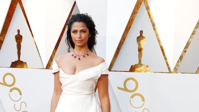 NEUTRAL TONES: Camilla Alves, wife of actor Matthew McConaughey wore a creamy white off the shoulder gown, nude make up and a string of rubies around her neck. The handkerchief hem, that gave glimpses of layers of netting gave just the right amount of interest to an otherwise delightfully understated look. EPA