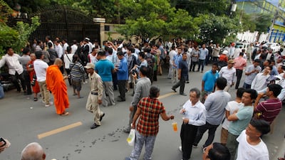People gather in front of Cambodians opposition leader Kem Sokha's home in Phnom Penh on September 10, 2018. AP Photo