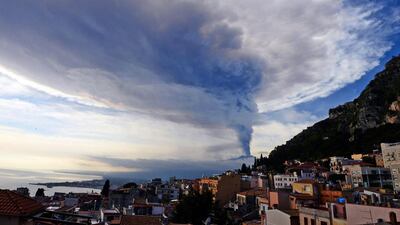 Smoke rises over the city of Taormina during an eruption of the Mount Etna, one of the most active volcanoes in the world, near Catania. Giovanni Isolino / AFP photo