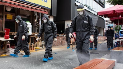 Health officials spray disinfectant as a precaution against the spread of coronavirus, on a street in Bupyeong, Incheon, South Korea. EPA