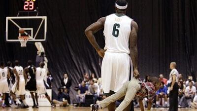 Miami Heat’s LeBron James holds his son, Bryce, during a charity game in Miami on Saturday. The players seemed to have a lot of fun.