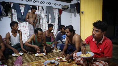 Mohamad Husein, right, from Myanmar, eats dinner at his hostel with his compatriots on the outskirts of Alor Setar, Kedah, northern Malaysia. For many fleeing Rohingya, Malaysia, is the preferred destination. Around 33,000 are registered there and an equal number are undocumented, according to the Rohingya Society of Malaysia. Those numbers have swelled with the violence in Myanmar. AP Photo/Vincent Thian