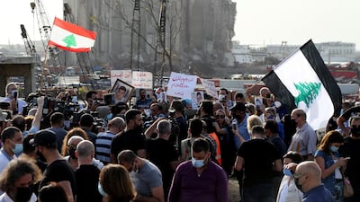 Families of August 4 Beirut port blast victims carry portraits of the deceased during a protest near the scene of explosion in the Lebanese capital, on May 4 2021. EPA