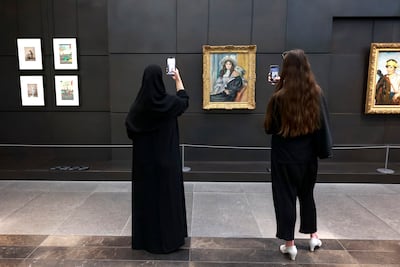 Visitors photograph Pierre-Auguste Renoir’s Berthe Morisot and Her Daughter, Julie Manet at Louvre Abu Dhabi. Photo: Victor Besa / The National
