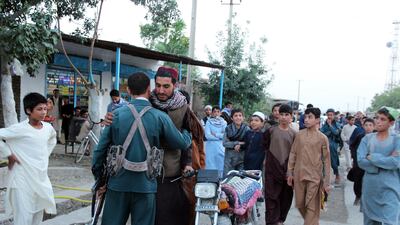 An alleged Taliban militant greets an Afghan policeman as a group of Taliban visit a bazaar to greet people as a goodwill gesture amid a three-day ceasefire on first day of Eid al-Fitr, in Kunduz, Afghanistan, 15 June 2018. Stringer / EPA