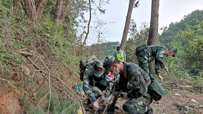 Paramilitary police officers work at the site where the aircraft crashed on March 21. Reuters