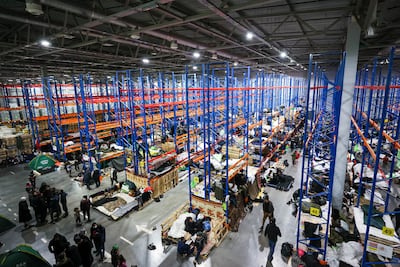 Some migrants have been moved to a warehouse on the Belarusian side of the border. Reuters