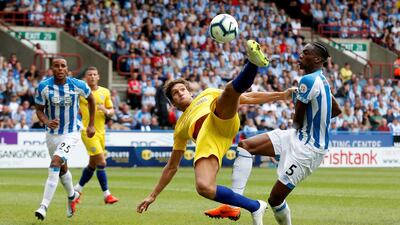 Chelsea's Marcos Alonso in action with Huddersfield Town's Terence Kongolo. Reuters