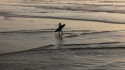 A Palestinian surfer on a beach west of Gaza City, on Saturday, February 22. EPA