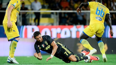 Cristiano Ronaldo goes down under the challenge of Frosinone midfielder Raman Chibsah. AFP