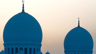 The sun rising over the Sheikh Zayed Grand Mosque's qubba, or domes, during Ramadan 2019. Victor Besa / The National