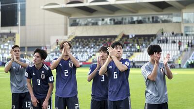 Japan's players acknowledge their supporters after defeating Turkmenistan.