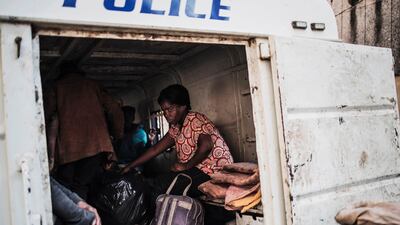 A pregnant homeless woman sits inside a police van in Johannesburg after having been rounded up by Johannesburg Metro Policemen. AFP