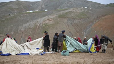 Survivors set up their temporary tents near the site of Friday's landslide that buried Abi-Barik village in Badakhshan province, northeastern Afghanistan. Massoud Hossaini / AP Photo