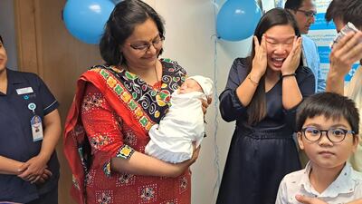 Neonatal specialist Dr Prem Tanwar, holding Zedrick, with his parents Maricel and Keith Madoginog and their son Zachary. Photo: NMC Hospitals