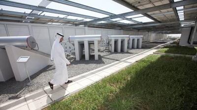 A Dewa employee walks in the garden of the green roof system at the sustainable building in Al Quoz. Developers will be required to install water and energy meters to obtain Leed accreditation. Jaime Puebla / The National