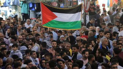 Jordanians wave the Palestinian flag as they gather to express their support for Gaza in Amman. AFP