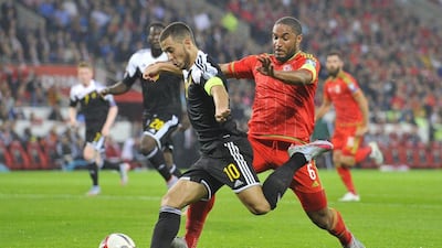Belgium's Eden Hazard goes to play the ball ahead of Wales' Ashley Williams during their Euro 2016 qualifying match on Friday night. Rebecca Naden / Reuters