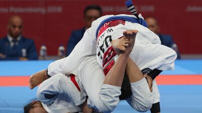 Jenna Kaila Napolis, left, of the Philippines in action against the UAE's Wadima Al Yafei, right, during the women's 49kg match. Adi Weda / EPA