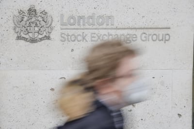 A pedestrian passes the London Stock Exchange in the Square Mile financial district of the City of London. Strong equity markets are making IPOs an attractive exit option once again. Bloomberg