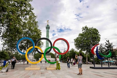 Visitors next to the Olympic and Paralympic rings at Place de la Bastille in Paris, France. Getty Images