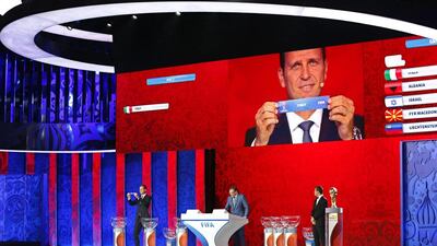 Oliver Bierhoff of Germany draws the ticket of Italy during the qualifying draw ceremony of the 2018 World Cup held at St Petersburg, Russia. Tatyana Zenkovich / EPA