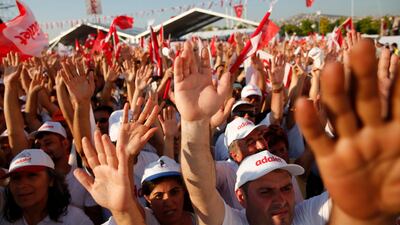 Supporters of Kemal Kilicdaroglu, the leader of Turkey's main opposition Republican People's Party, raise their hands as they gather for a rally in Maltepe, Istanbul on July 9, 2017, celebrating the end of Mr Kilicdaroglu's 425-kilometre 'March for Justice' from Ankara to Istanbul. Lefteris Pitarakis / AP Photo