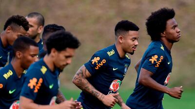 Brazil players Gabriel Jesus, second right and Willian, right, go through a warm-up. AFP