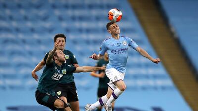 Manchester City's Phil Foden heads the ball away from Burnley's Josh Brownhill. AP Photo