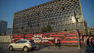 A man passes the Ataturk Cultural Centre in Istanbul, which opened in 1969 to realise the dream of modern Turkey's founder Mustafa Kemal Ataturk for the country to be a world-class centre for the arts, including western genres like classical music, opera and ballet. Ozan Kore/AFP