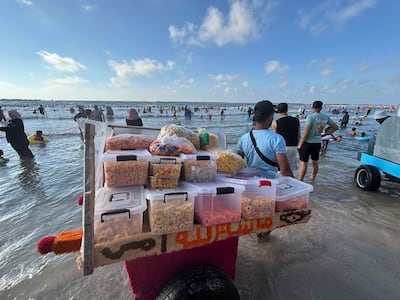 Vendors stand along the shoreline at Egypt’s Mediterranean resort of Ras El Bar. Hamza Hendawi / The National