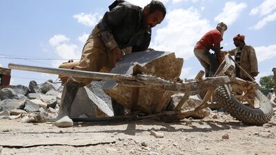 Yemeni labourers work at a stone workshop on the International Labor Day, in Sana'a, Yemen. EPA