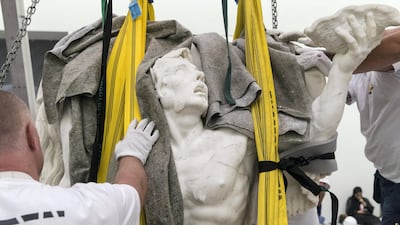 It took a 15-strong team six hours to rebuild and manhandle the work into place. Christopher Pike / The National